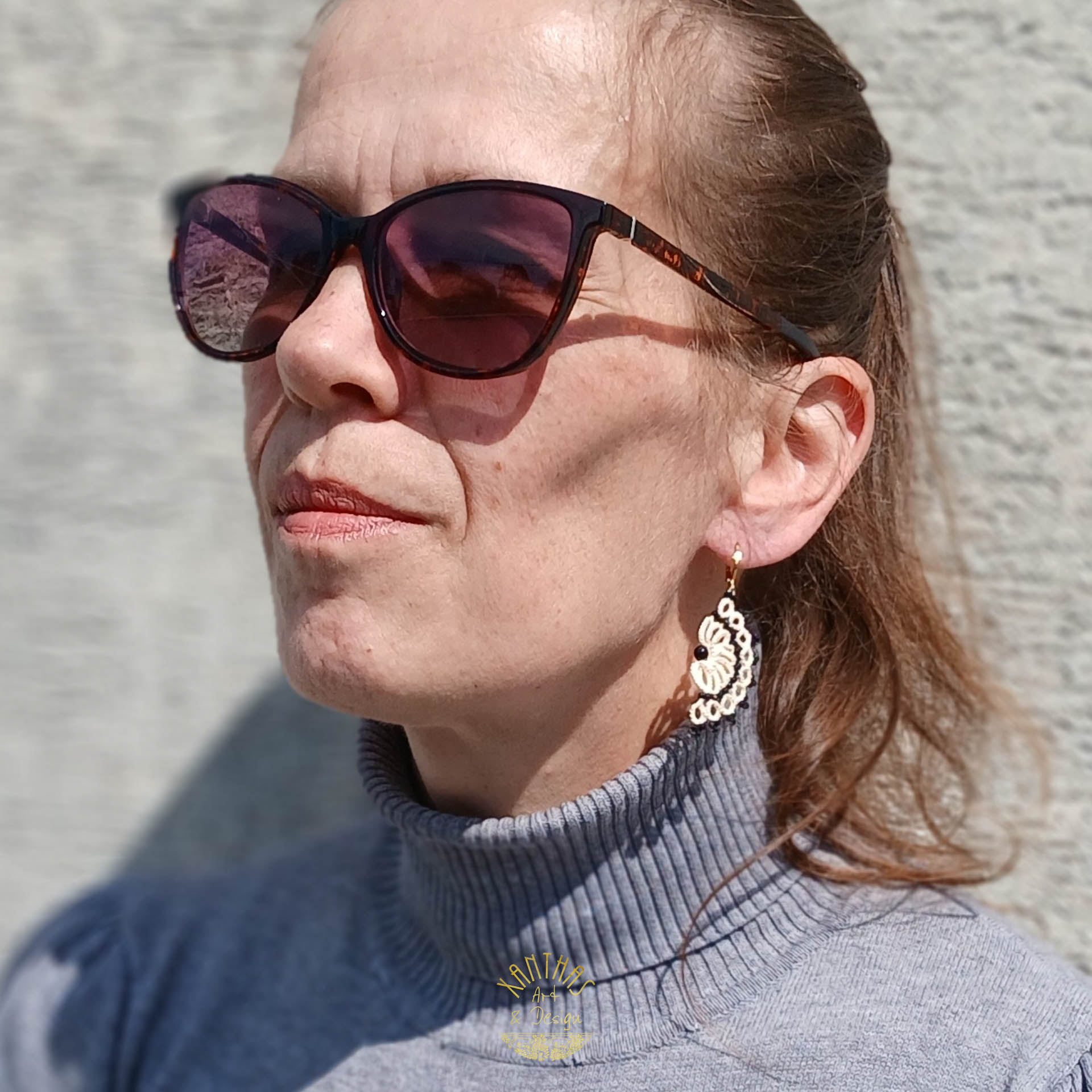 Ohrhänger „Clio“ aus handgefertigter Frivolitätenspitze in Bananengelb mit halbmondförmigem Design, Onyx-Perle in der Mitte und winzigen, facettierten Spinellperlen. Die Brisuren sind aus goldfarbigem, hypoallergenem Edelstahl.